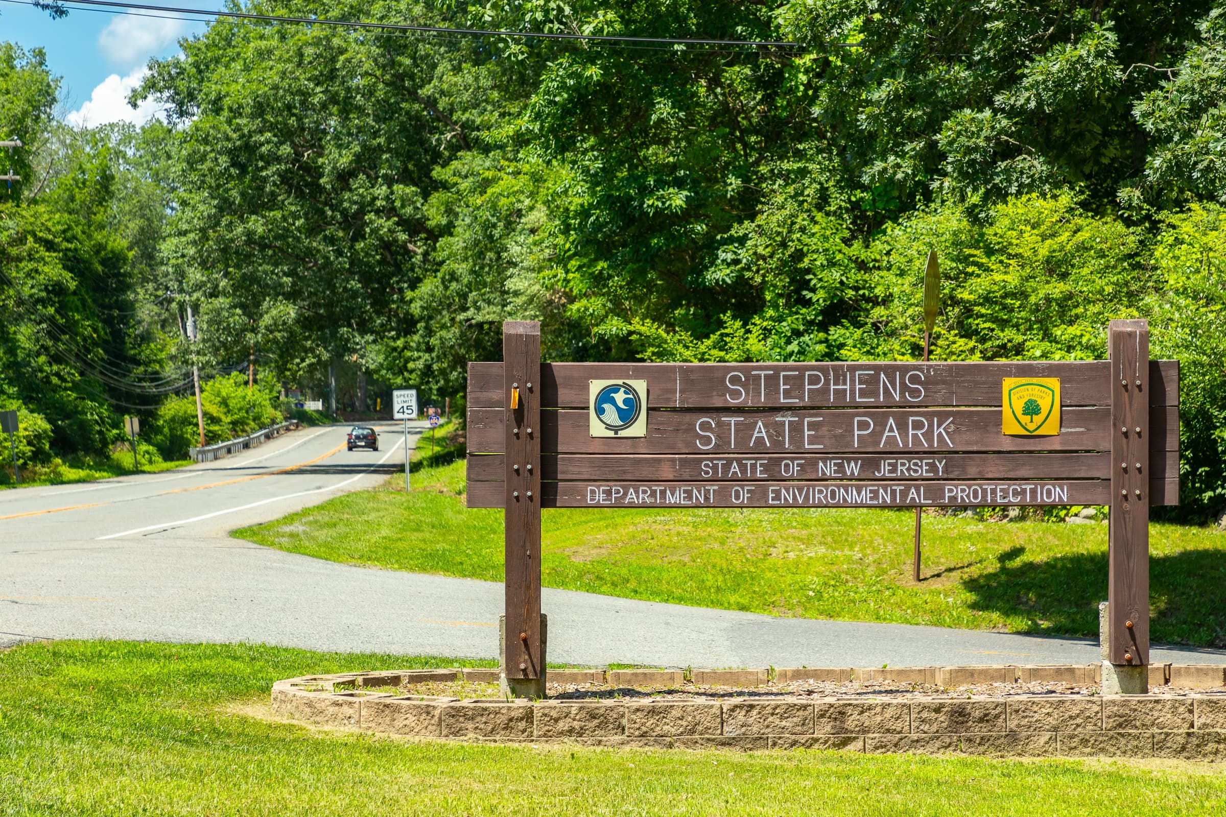 A sign for Stephens State Park is displayed in front of a road.