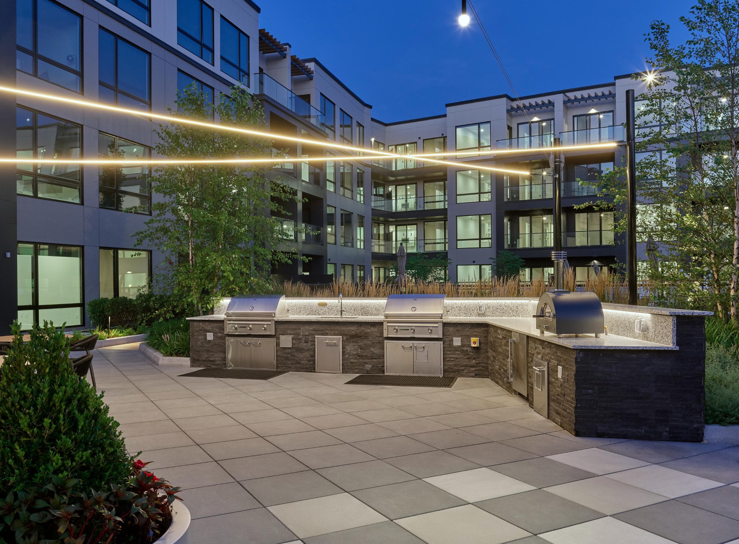 A modern building with a courtyard and a long row of windows.