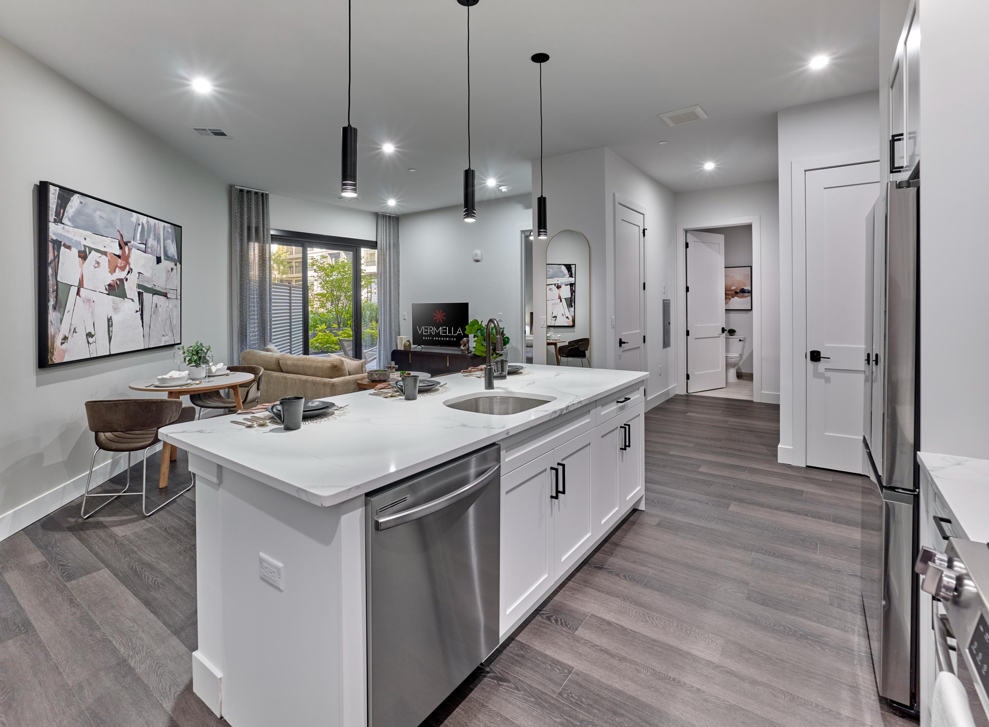 A modern kitchen with a large island and stainless steel appliances.