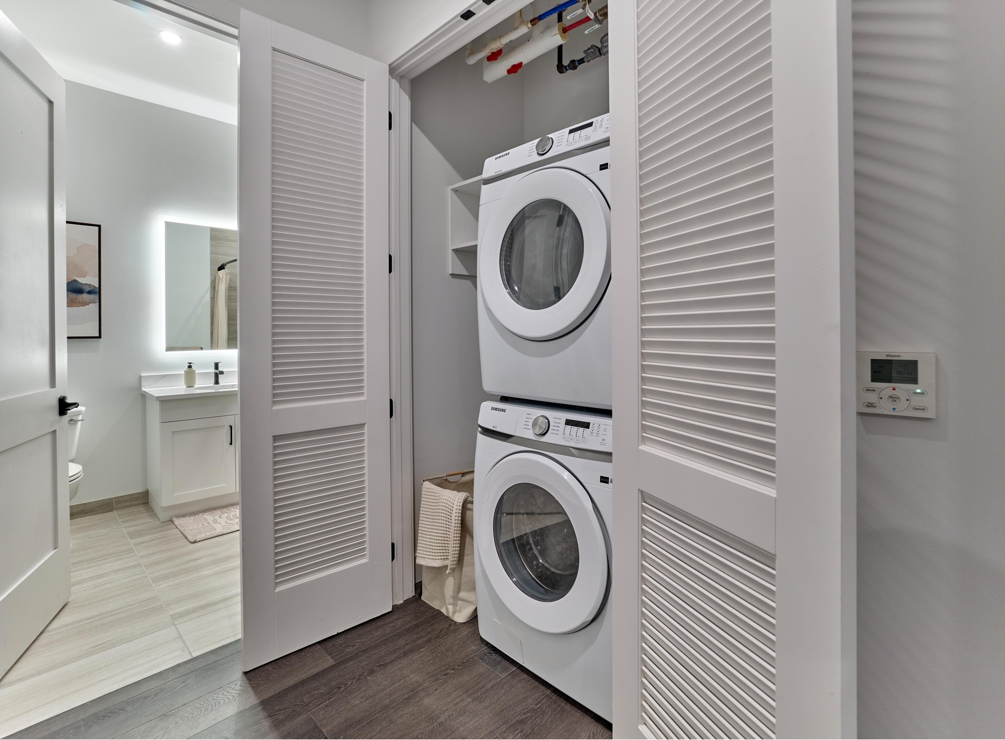 A white washing machine is in a small laundry room.