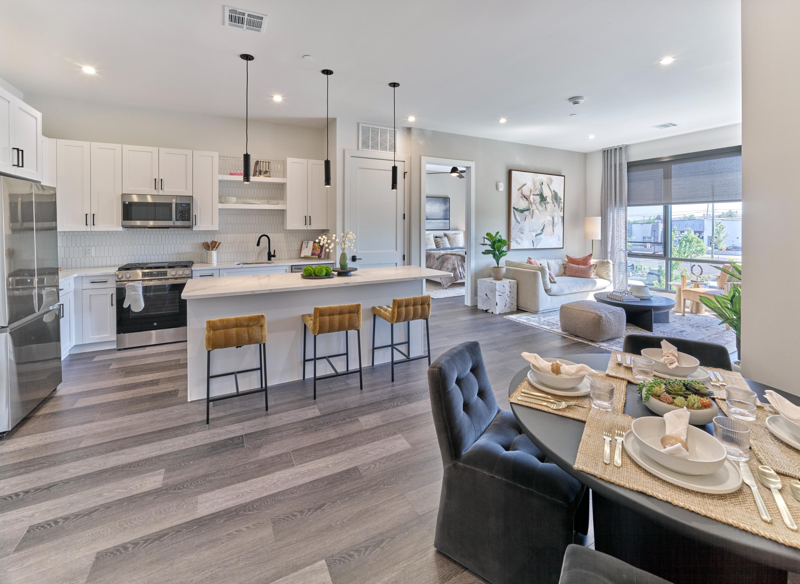 A modern kitchen with a dining table set for four.
