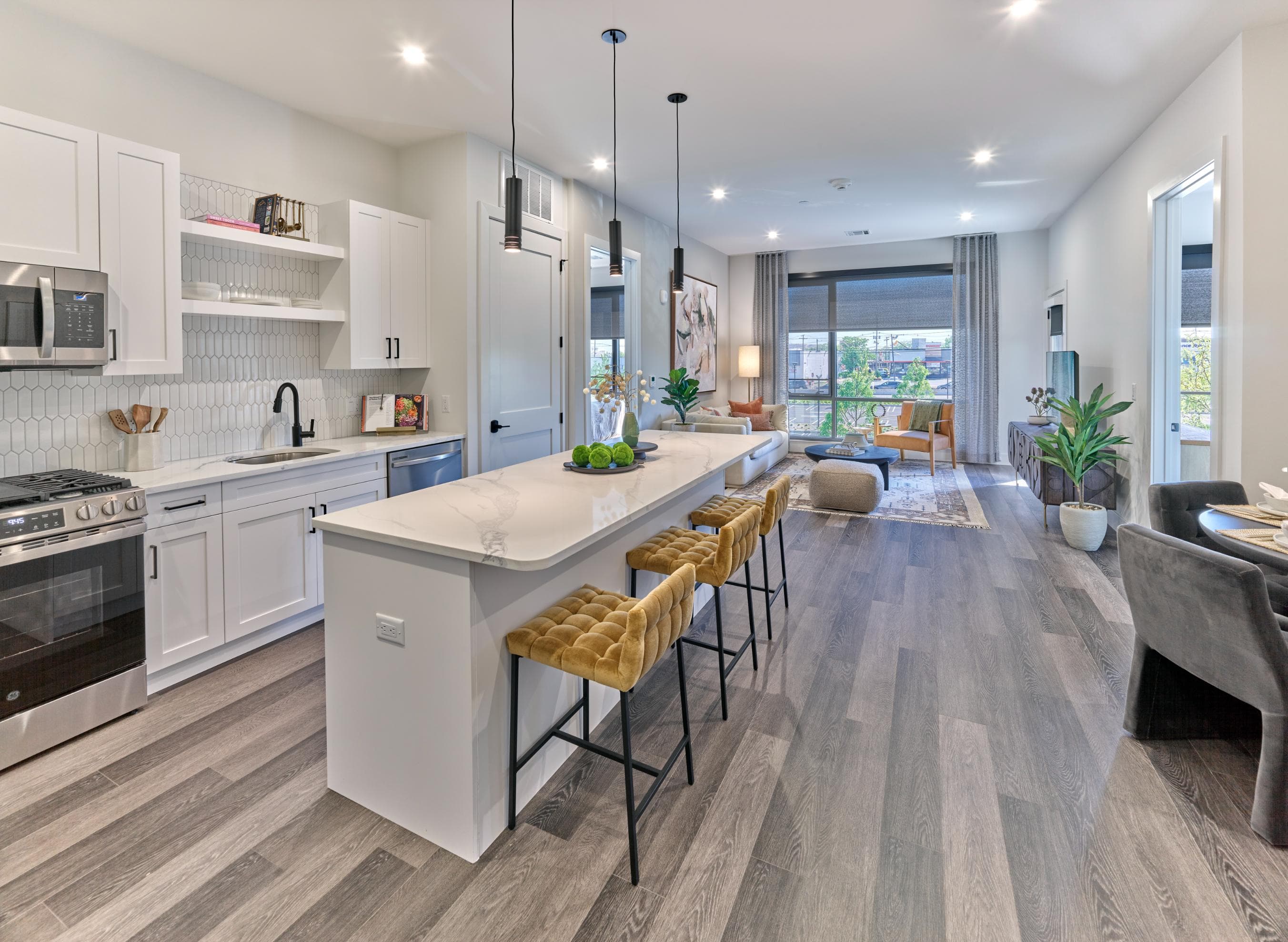 A modern kitchen with a large island and bar stools.
