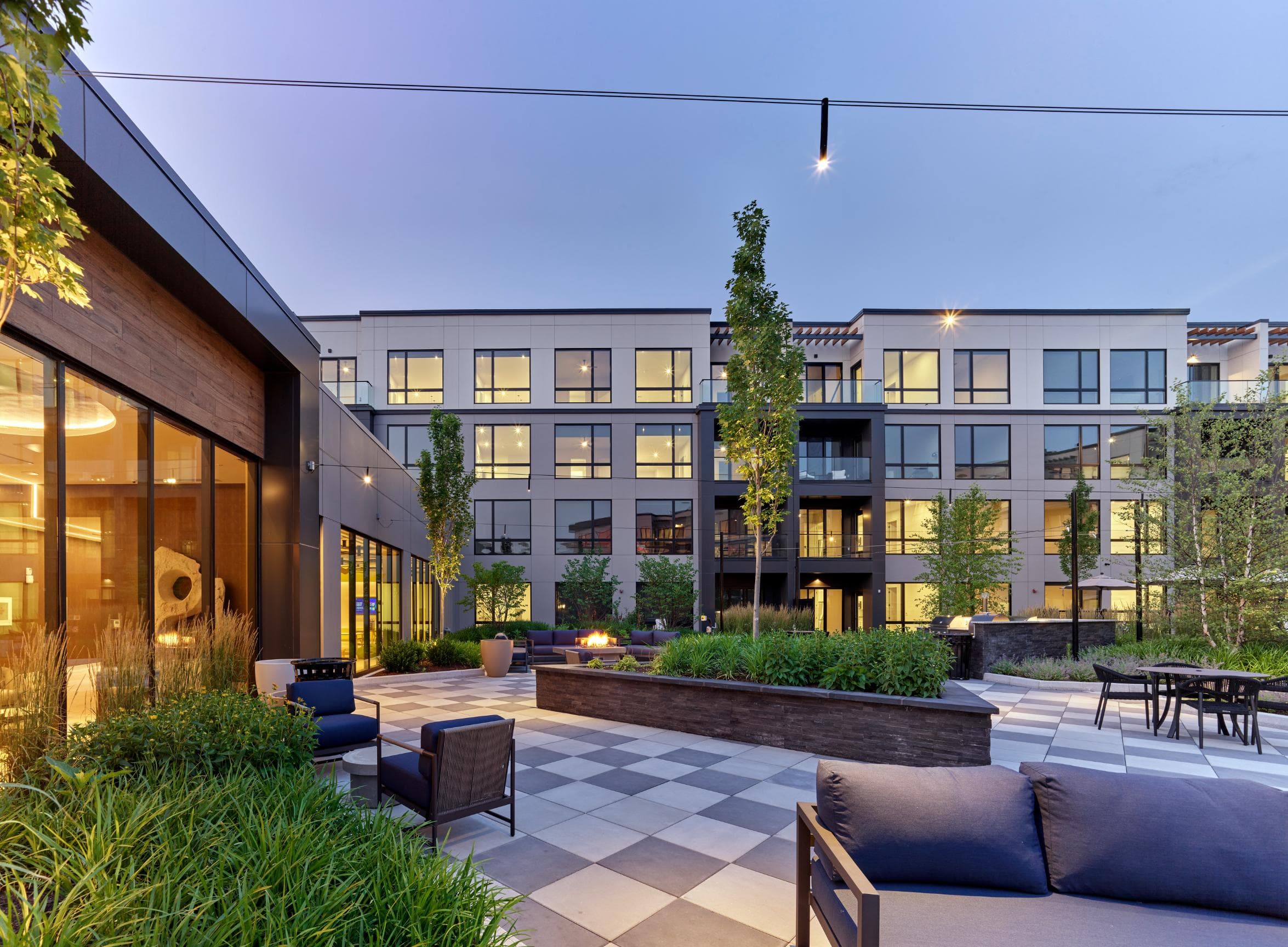 A modern outdoor seating area with a checkerboard patterned floor.