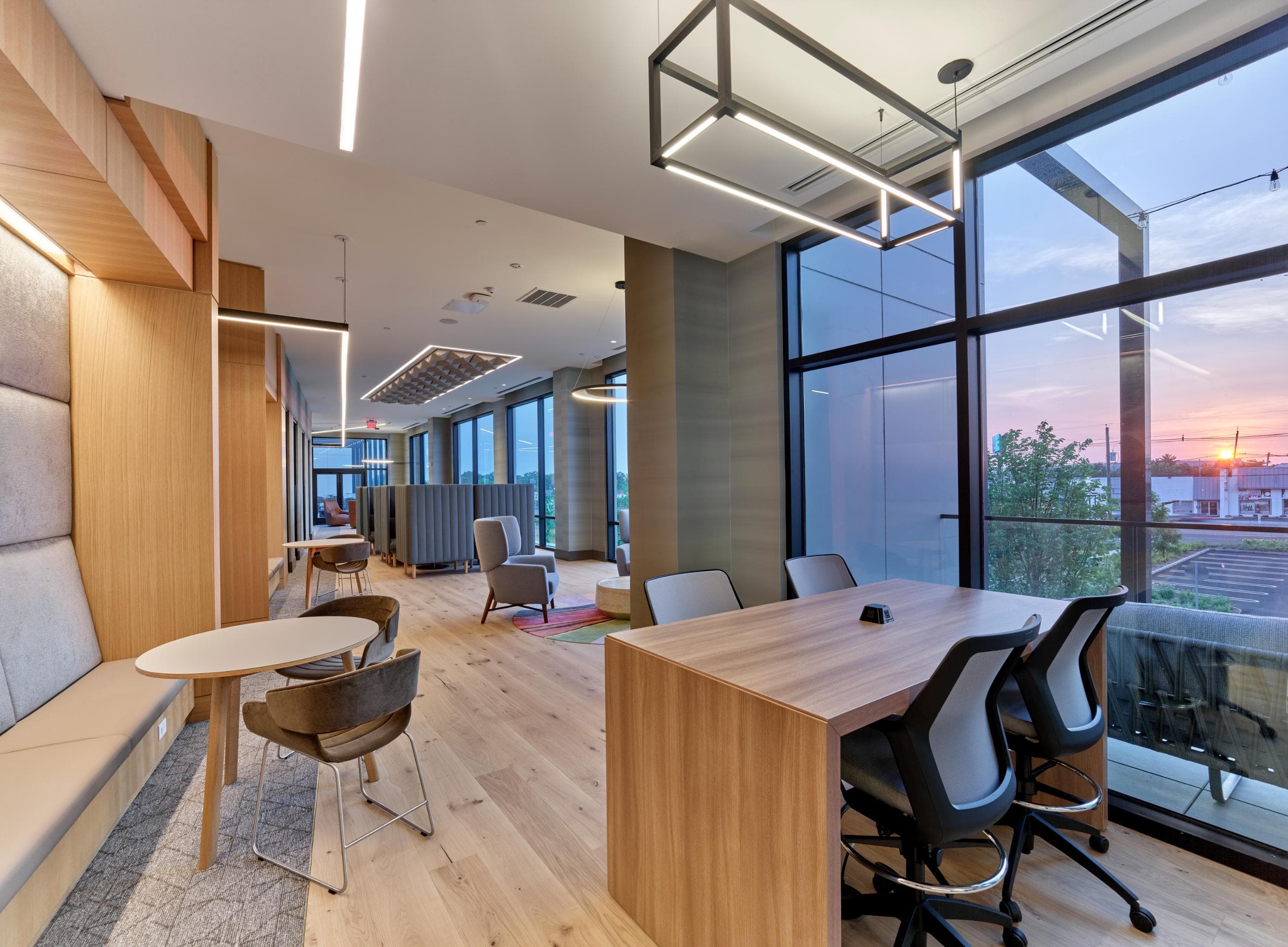 A modern office space with wooden furniture and large windows.