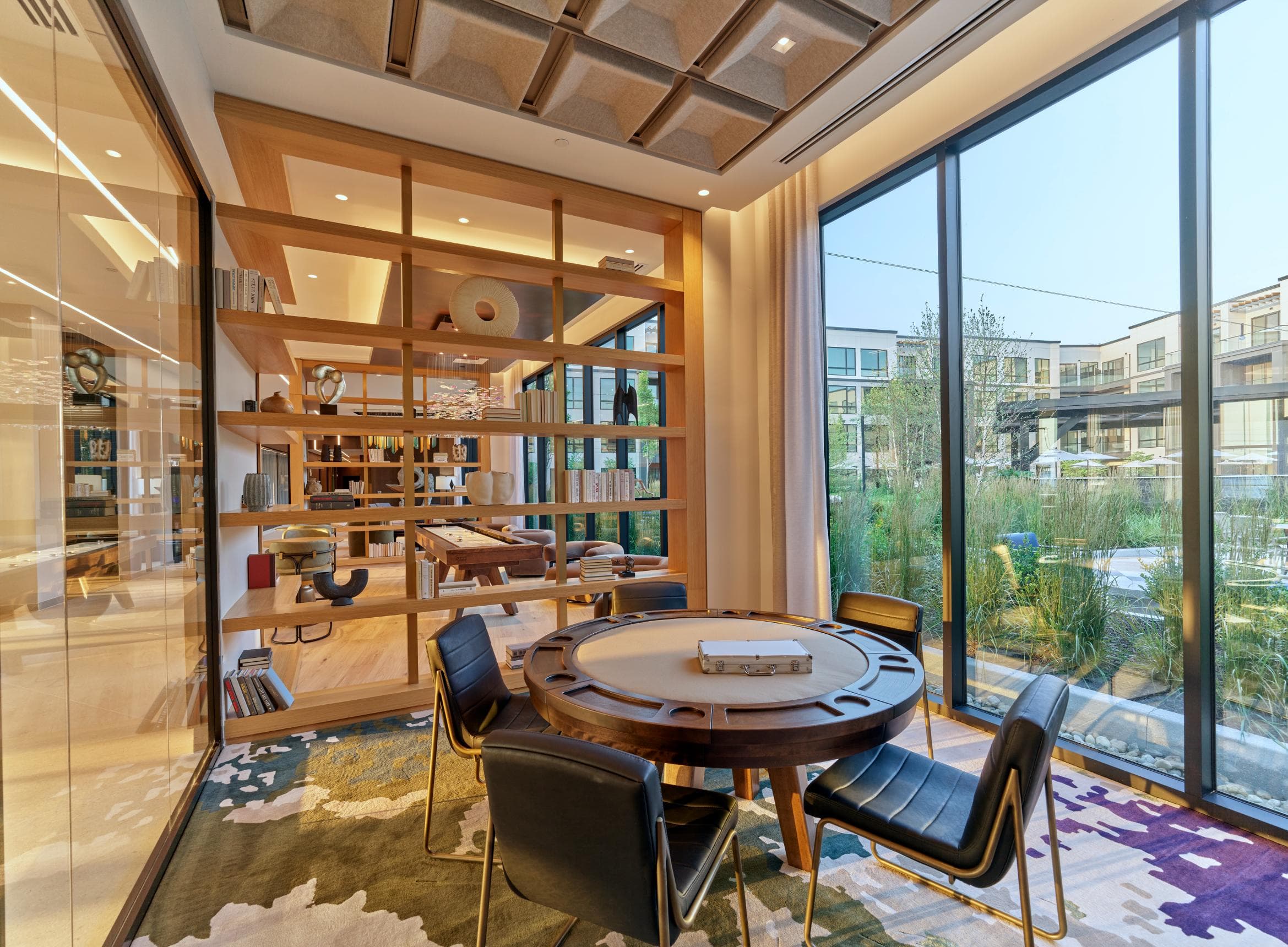 A modern dining room with a round table and chairs.