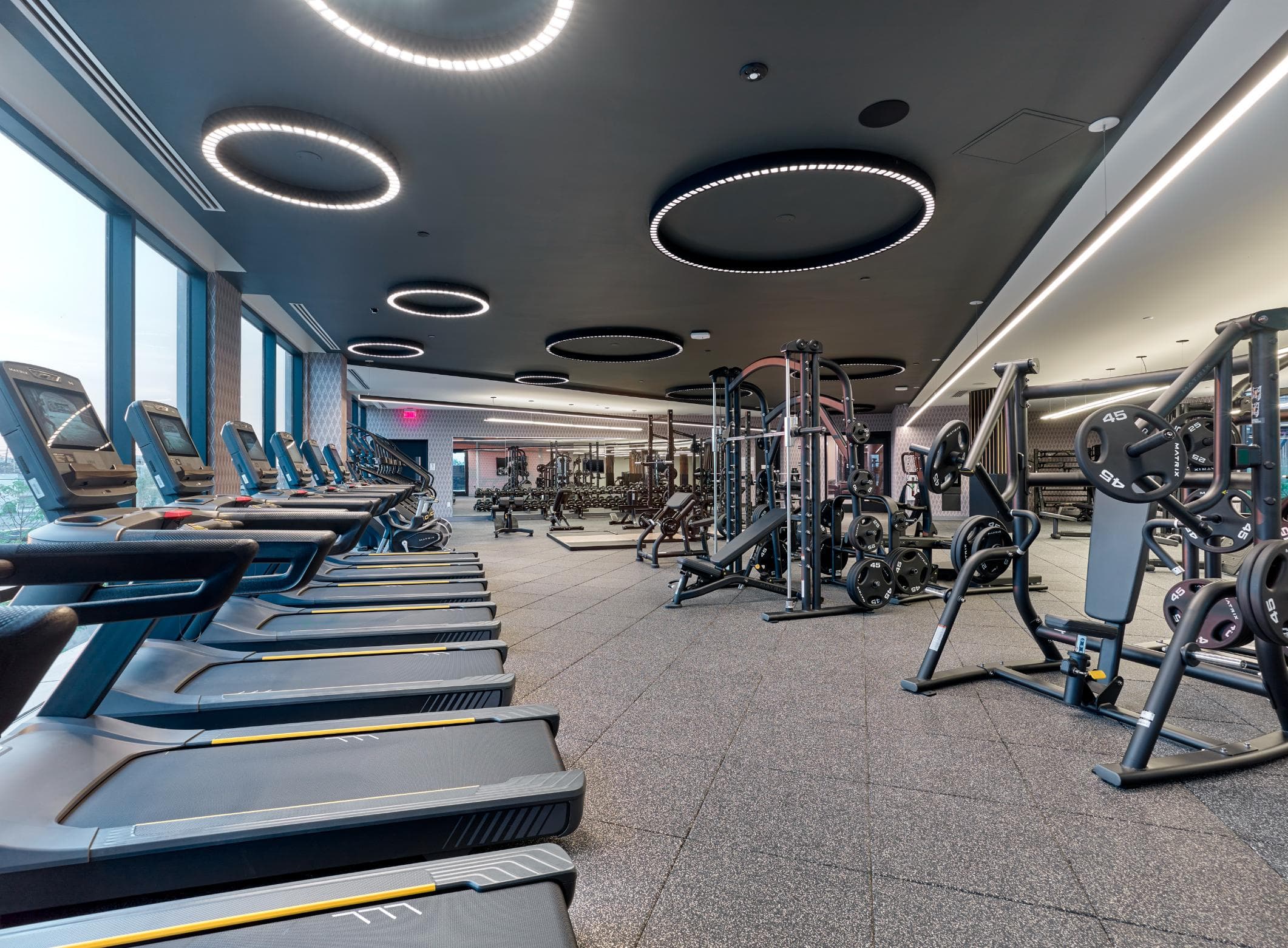A gym with treadmills and other exercise equipment.