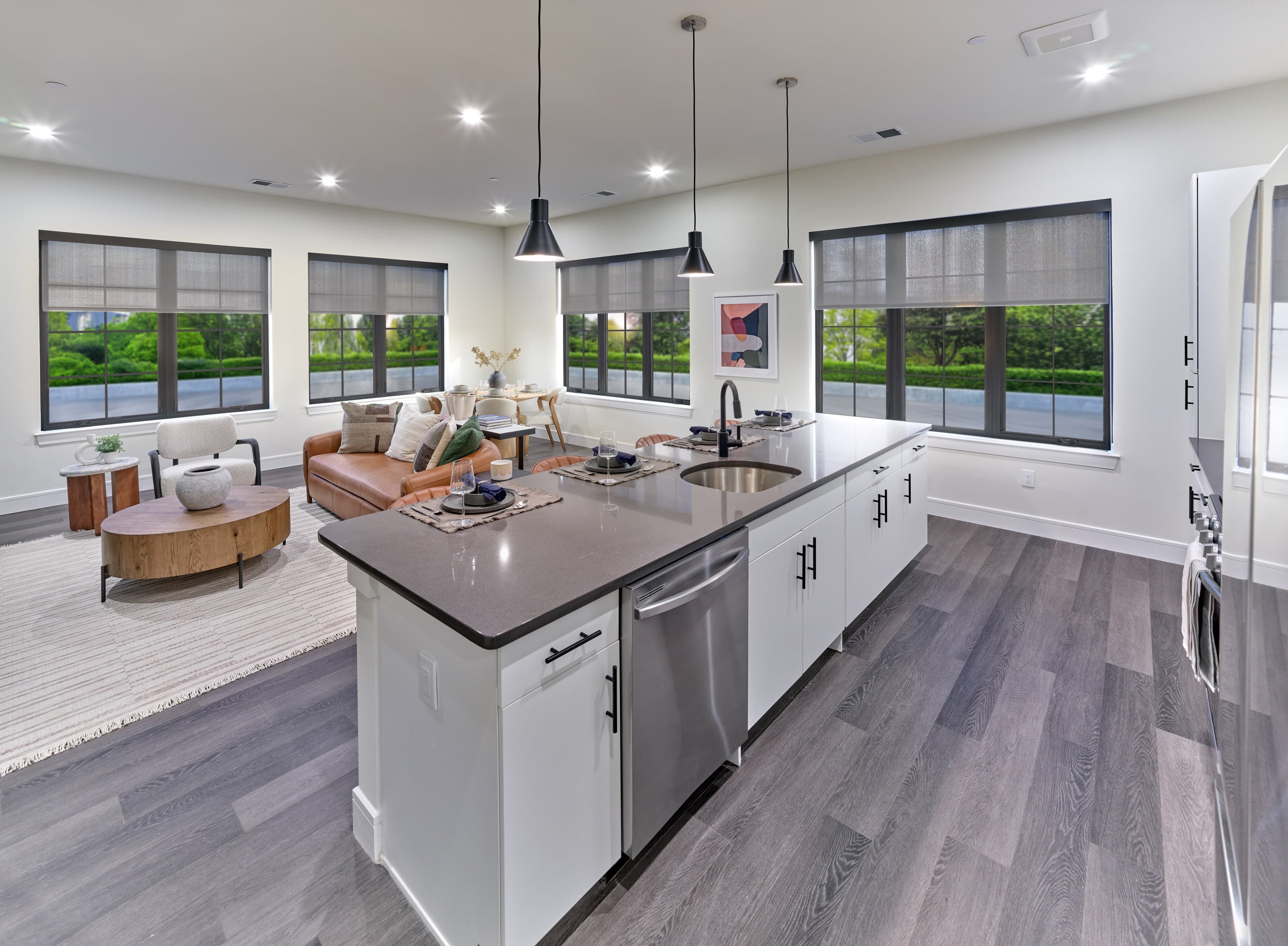 A modern kitchen with a large island and a view of the outdoors.