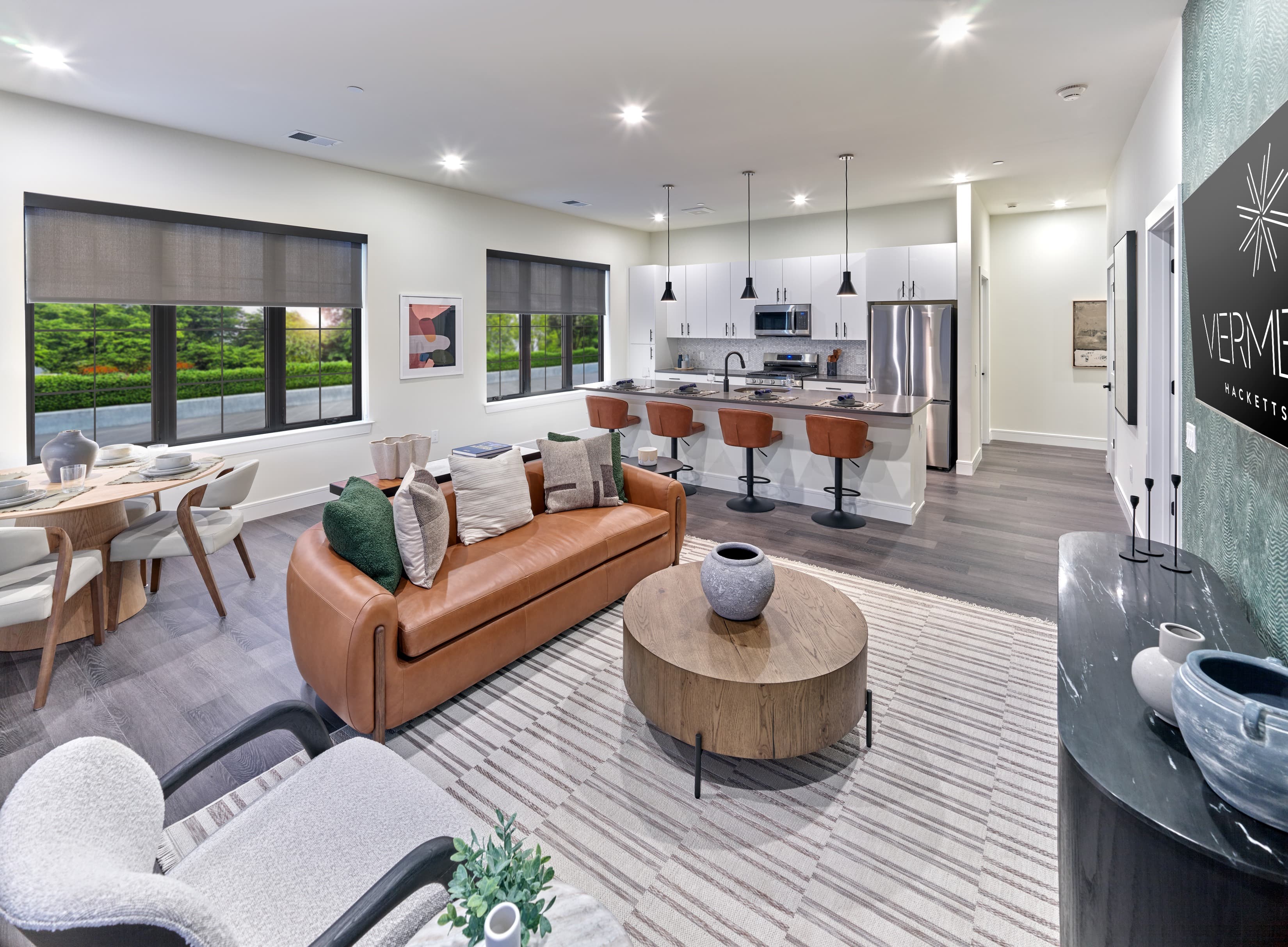A living room with a couch, chairs, and a coffee table.