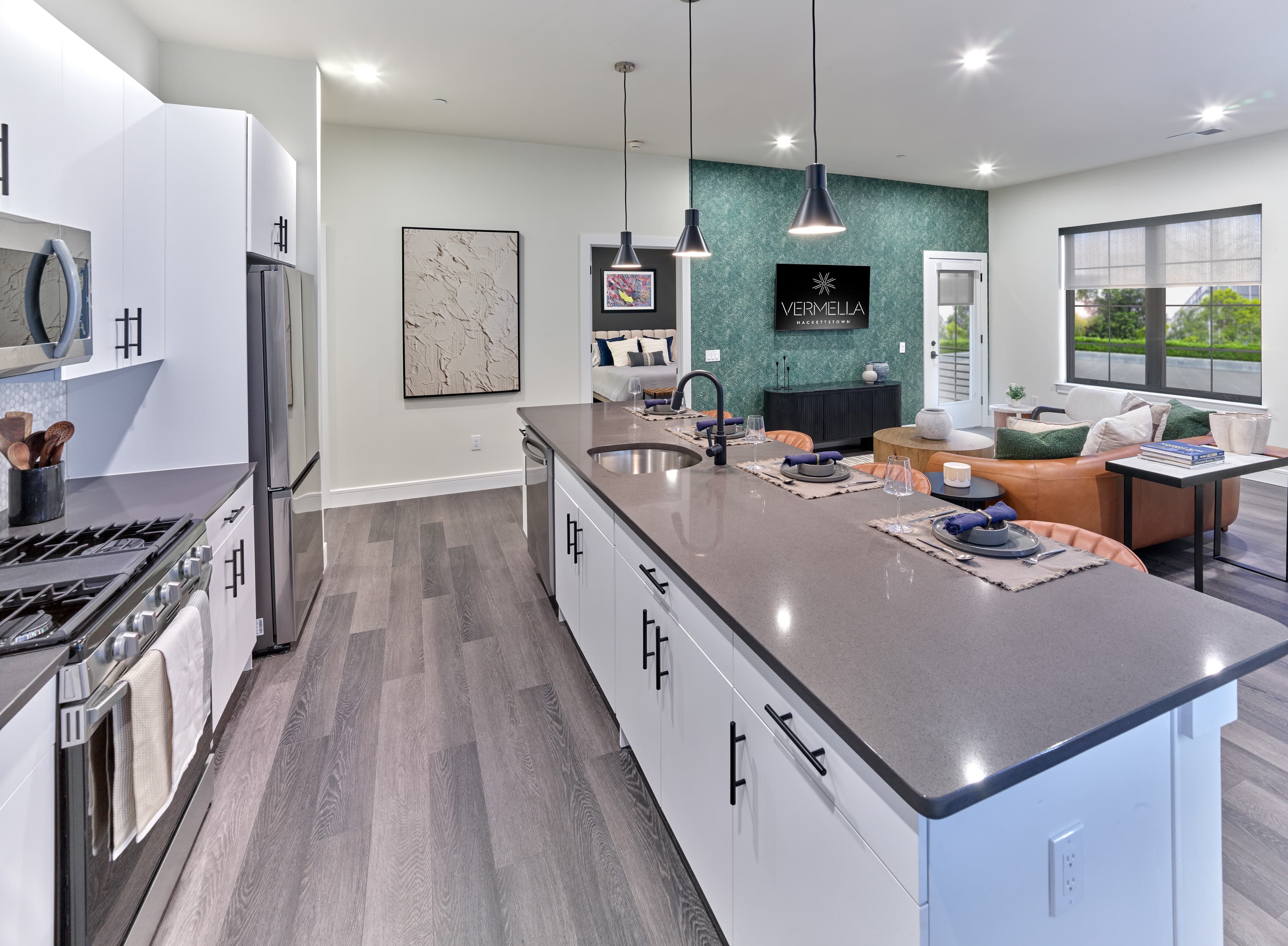 A modern kitchen with a large island and a dining area.