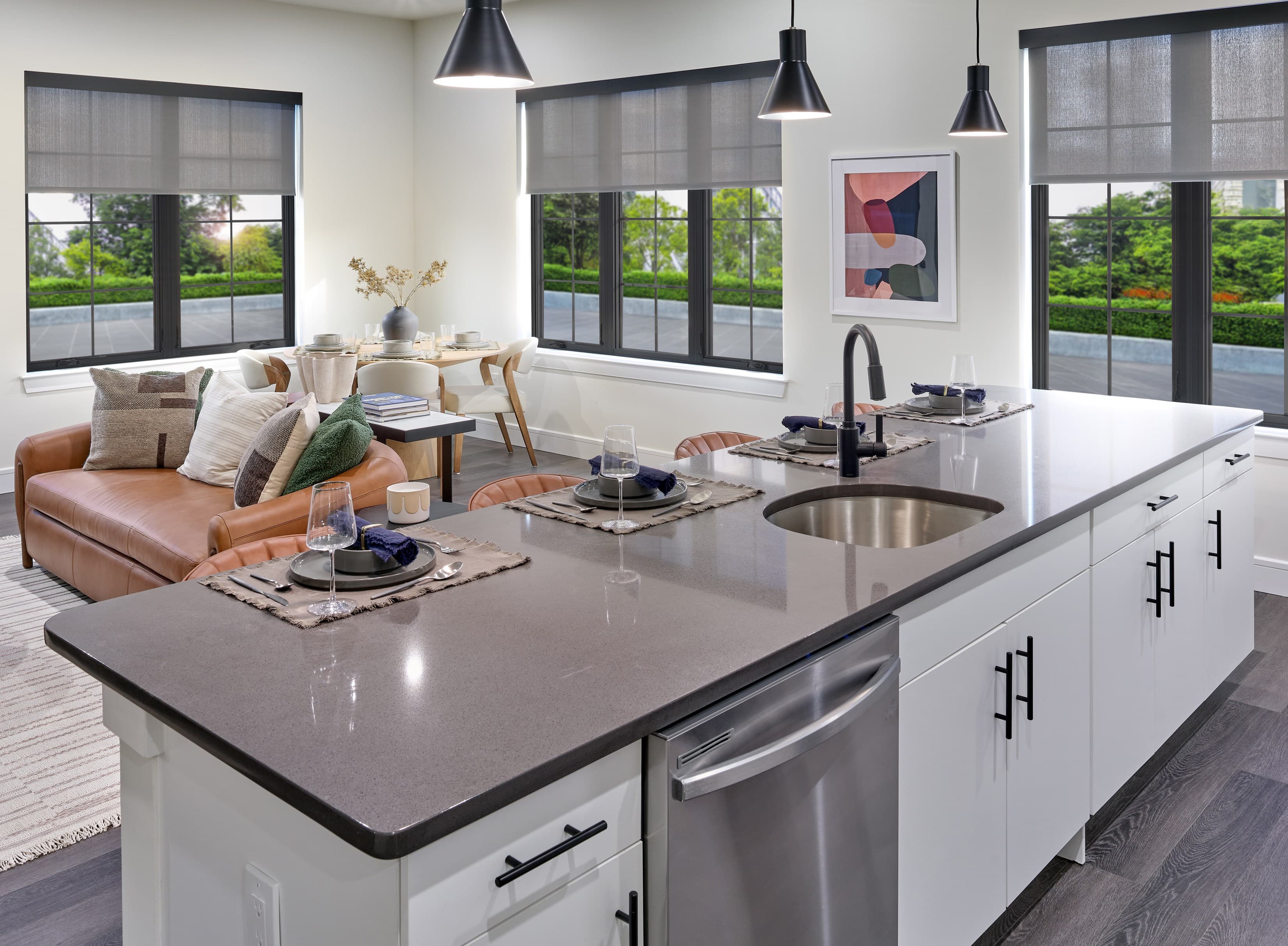 A modern kitchen with a large island and a view of the backyard.
