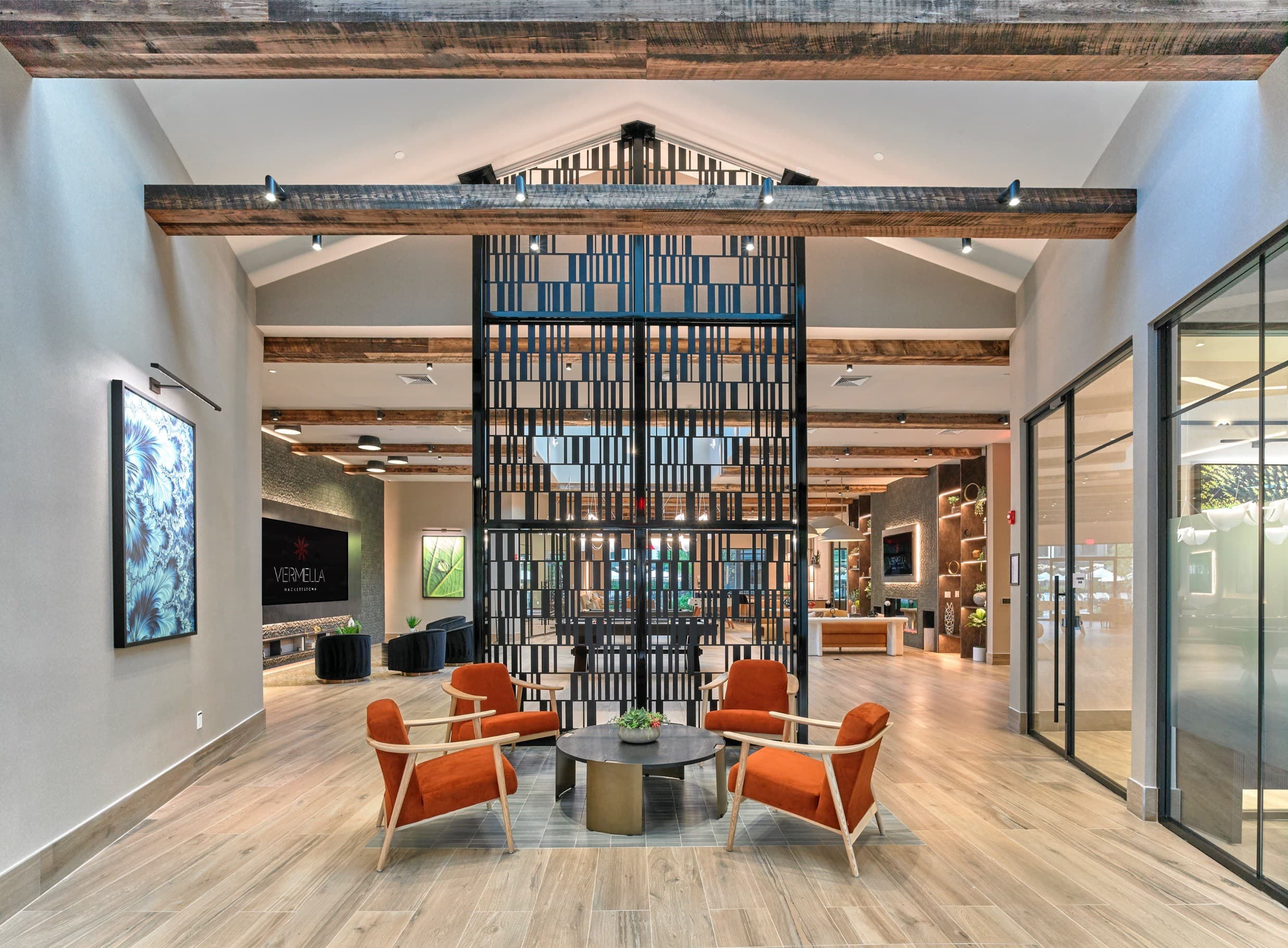 A modern interior with a wooden ceiling and a glass partition wall.