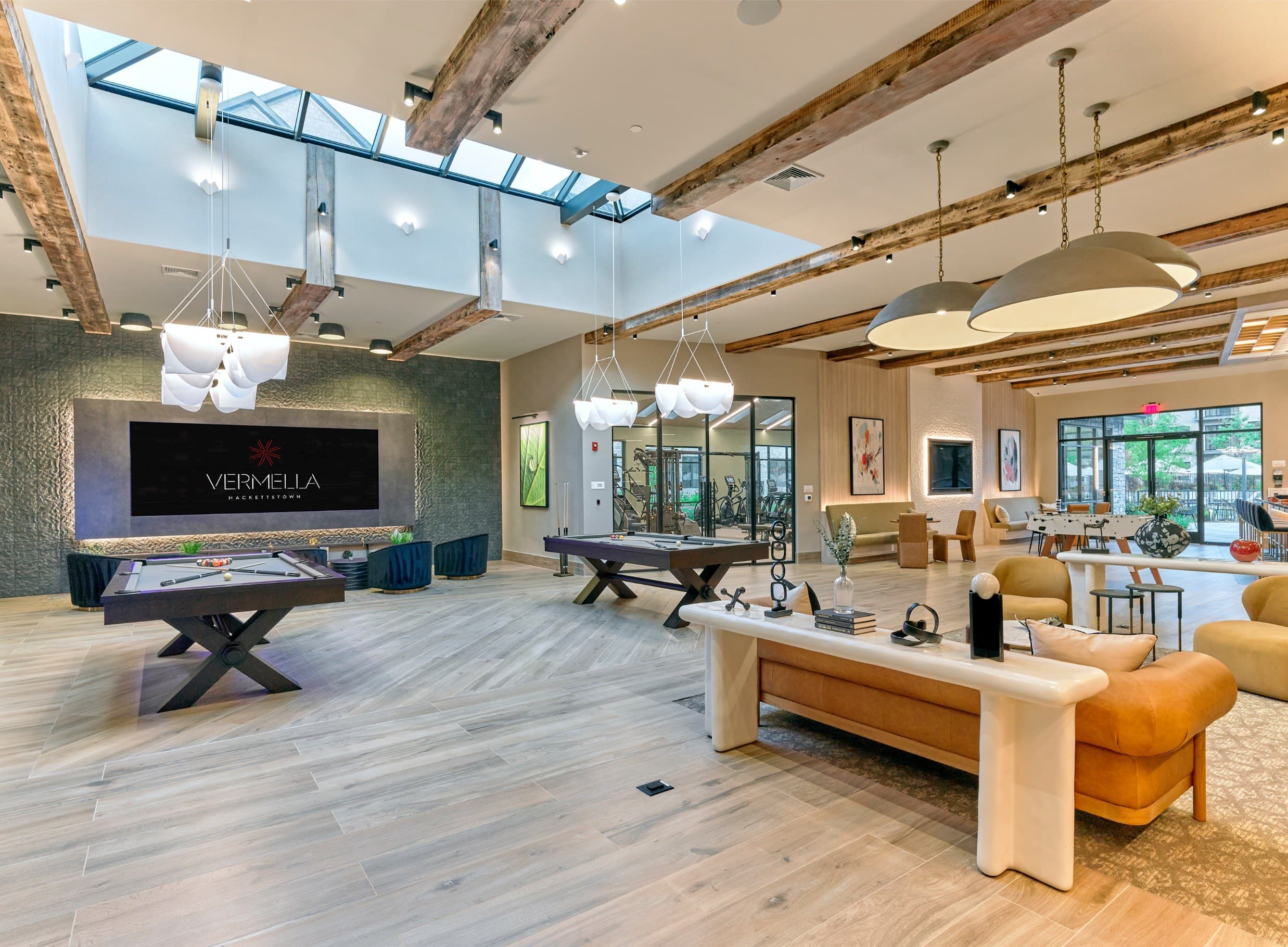 A living room with a pool table and a sign that says