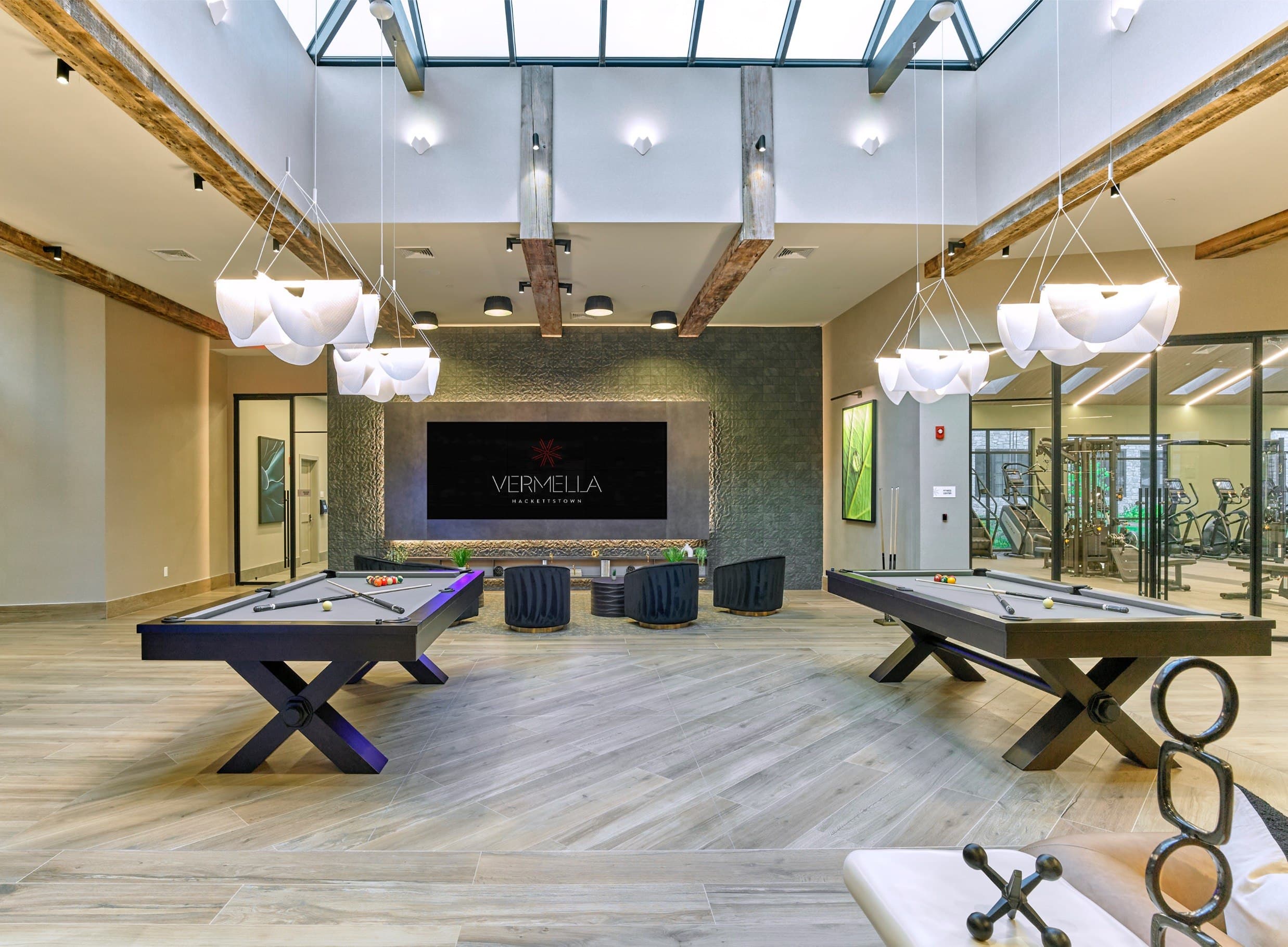 A room with a pool table and a foosball table.