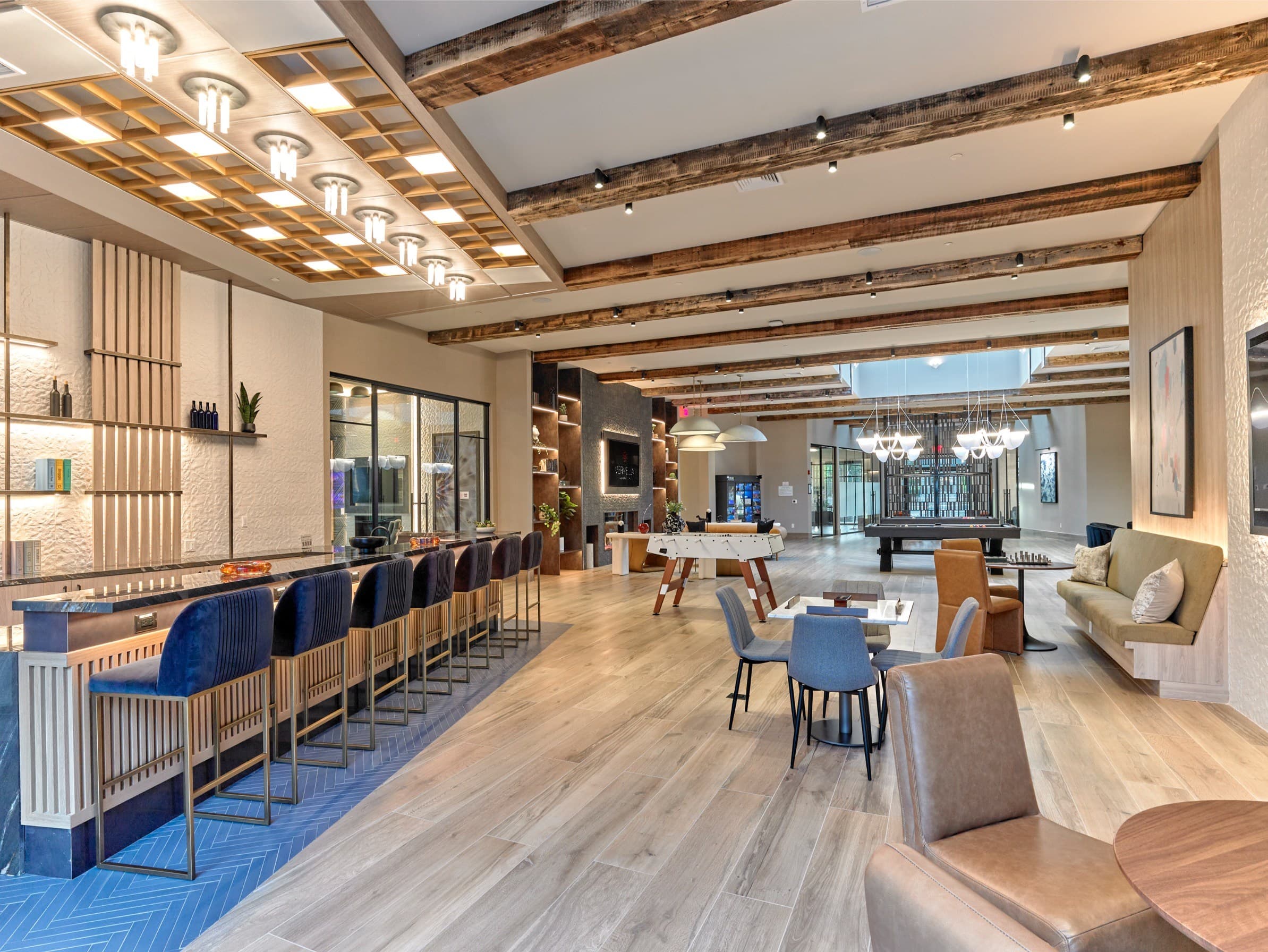 A modern living room with a bar area and a dining table.