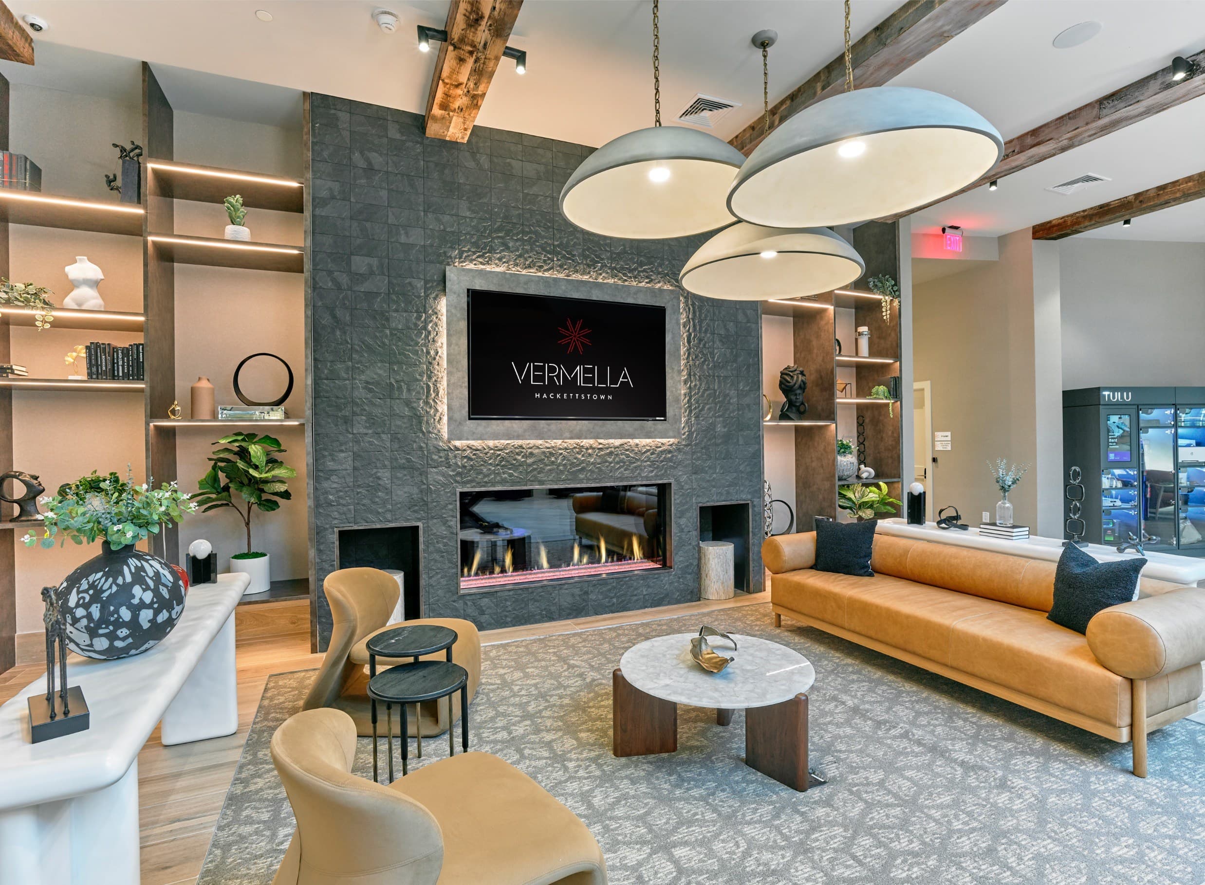 A living room with a fireplace and a sign that says