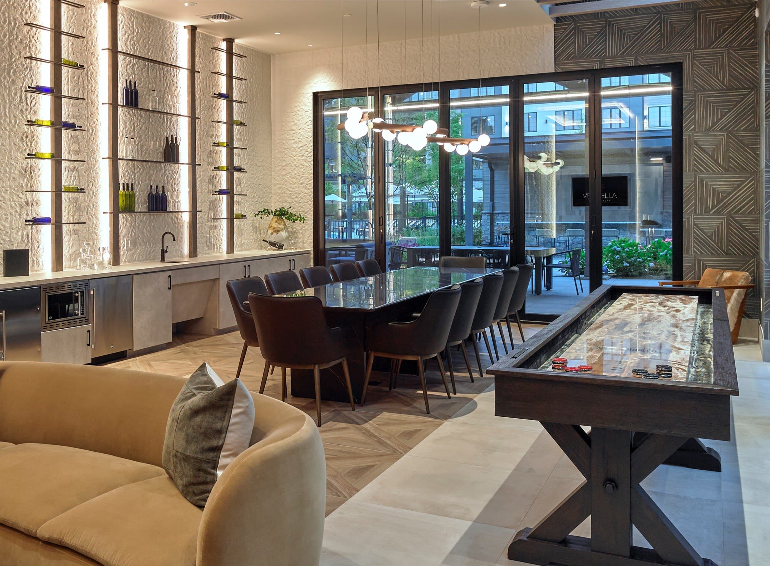 A modern living room with a pool table and a bar area.