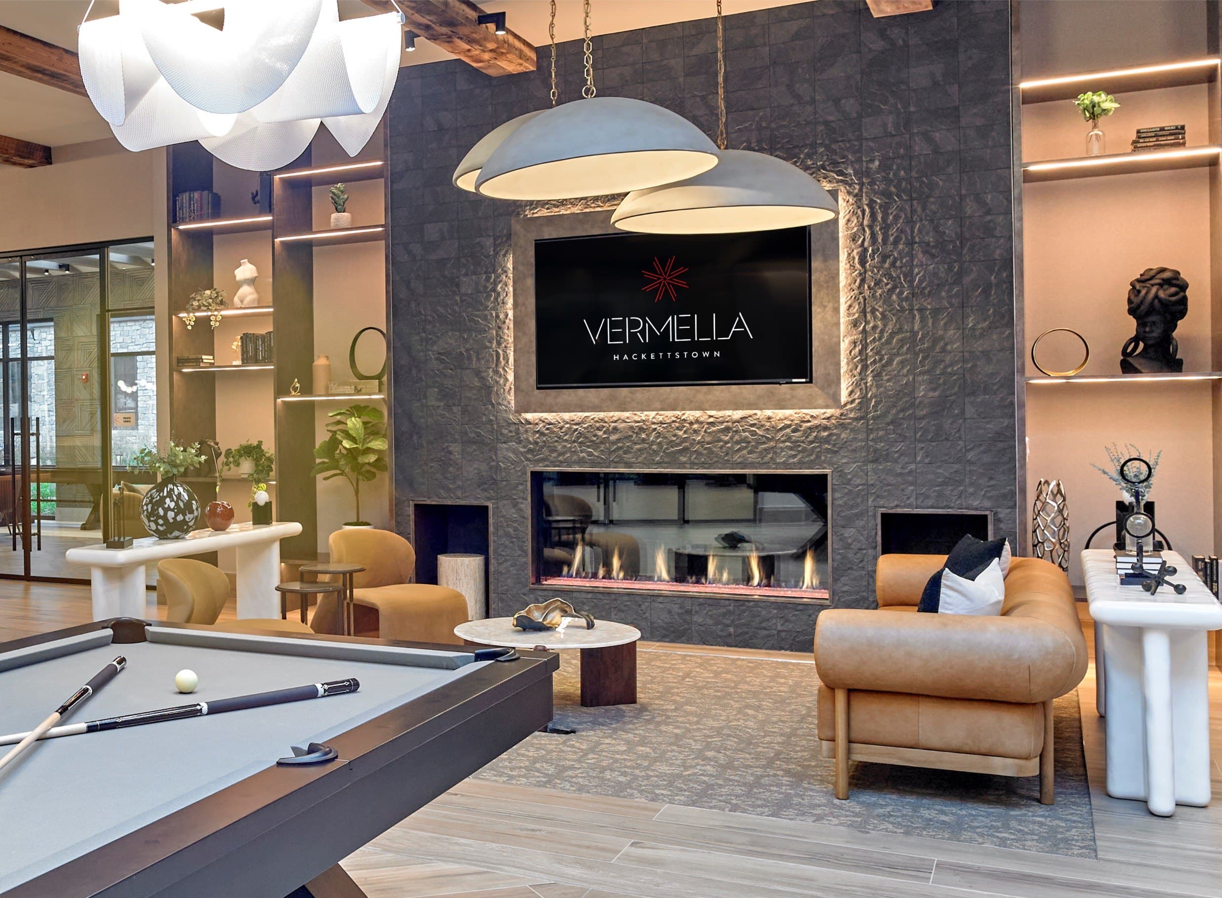 A living room with a pool table and a fireplace.