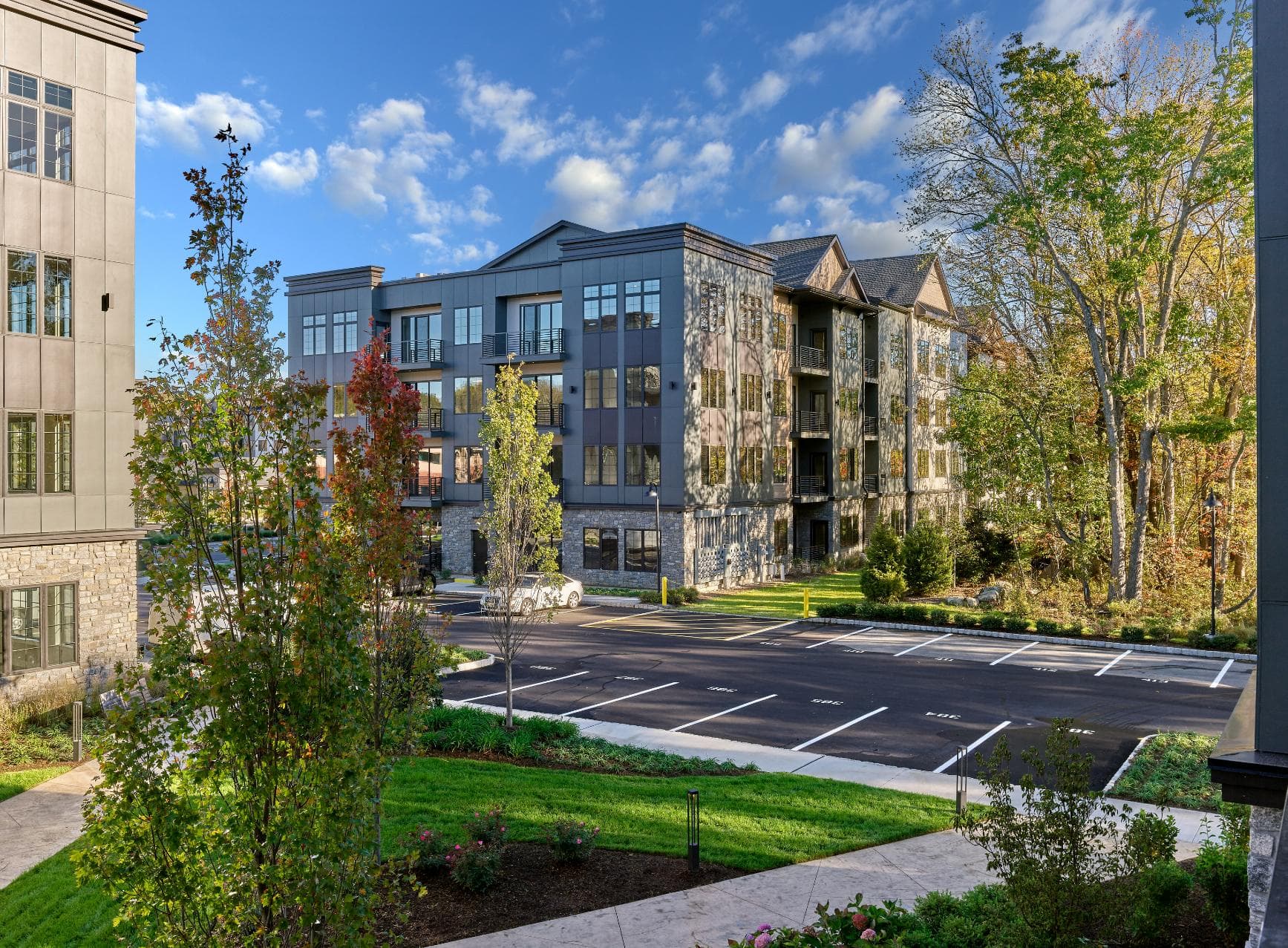 A large building with a parking lot in front of it.